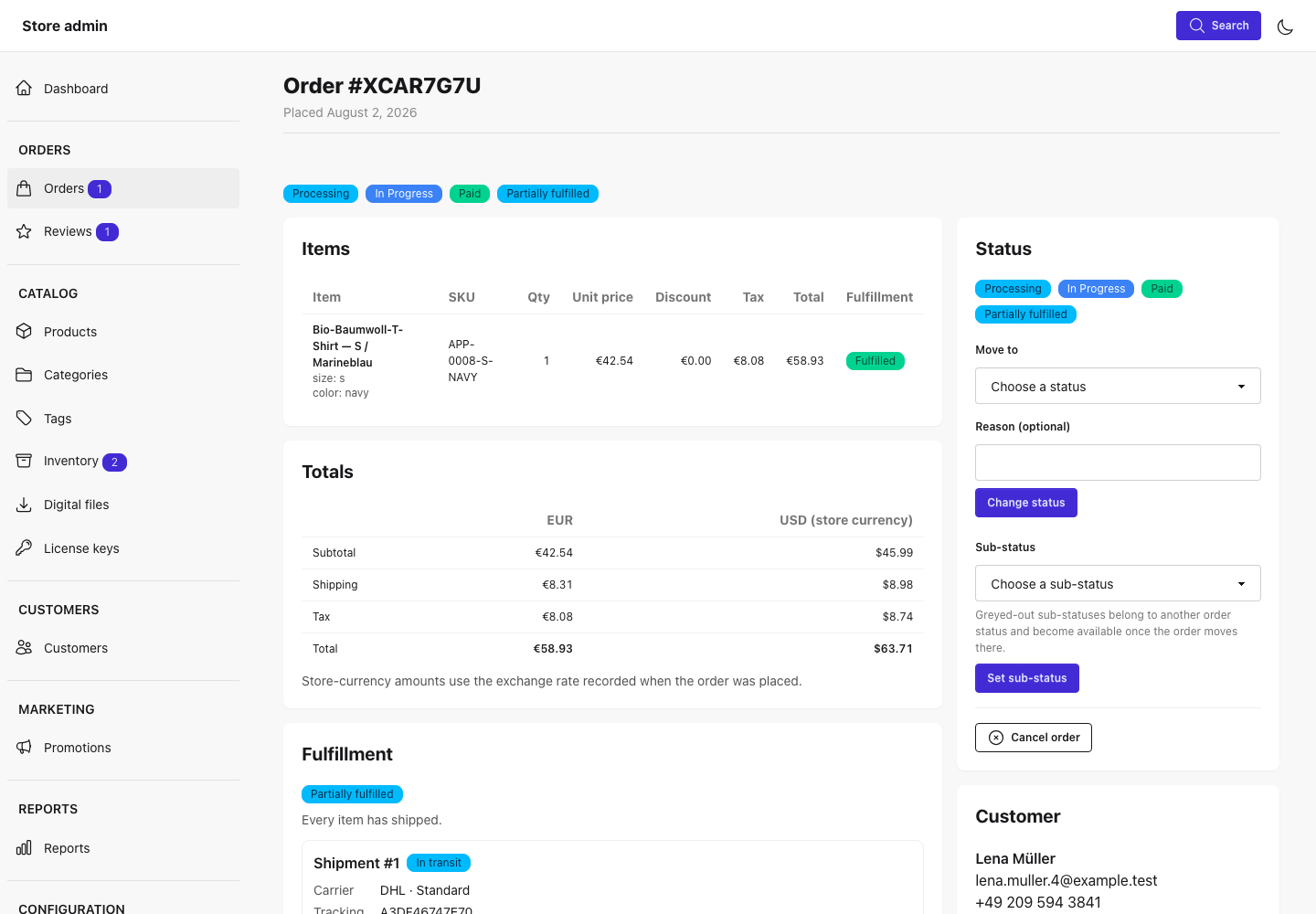 An order's detail page: status badges, the items table, totals in the order currency and the store currency, and fulfillment with a shipment in transit, beside a status panel for changing status and sub-status or cancelling the order