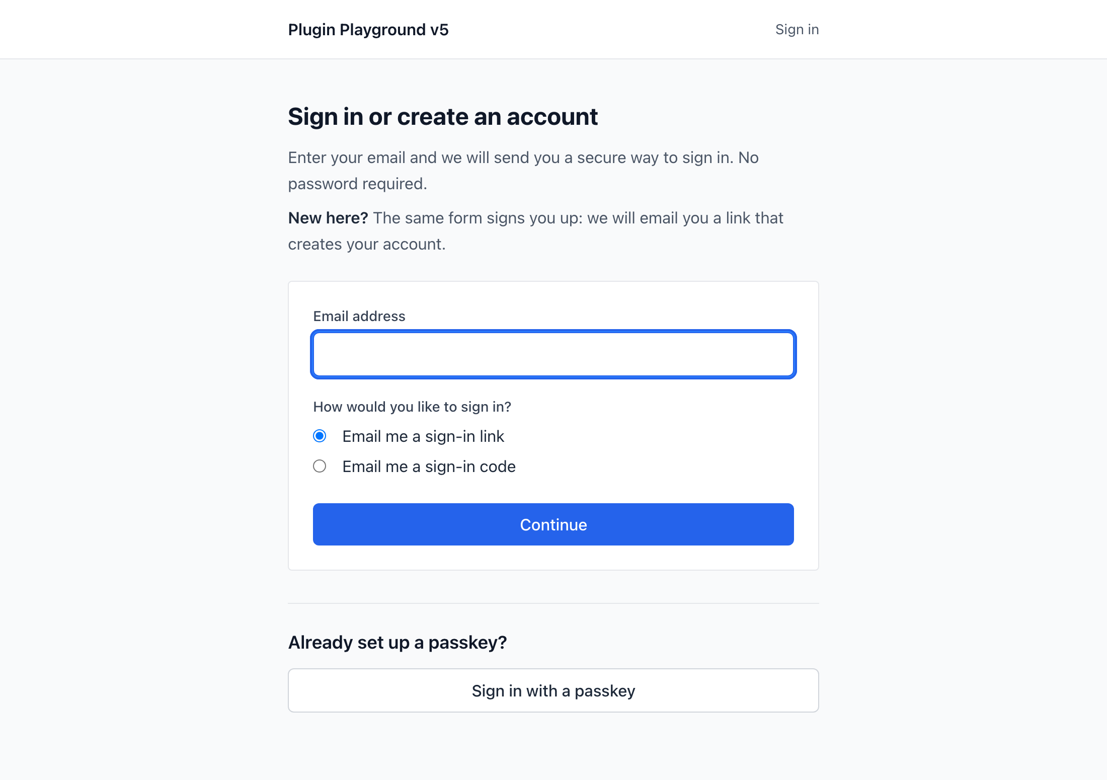 The example login page, with both email channels and the passkey button