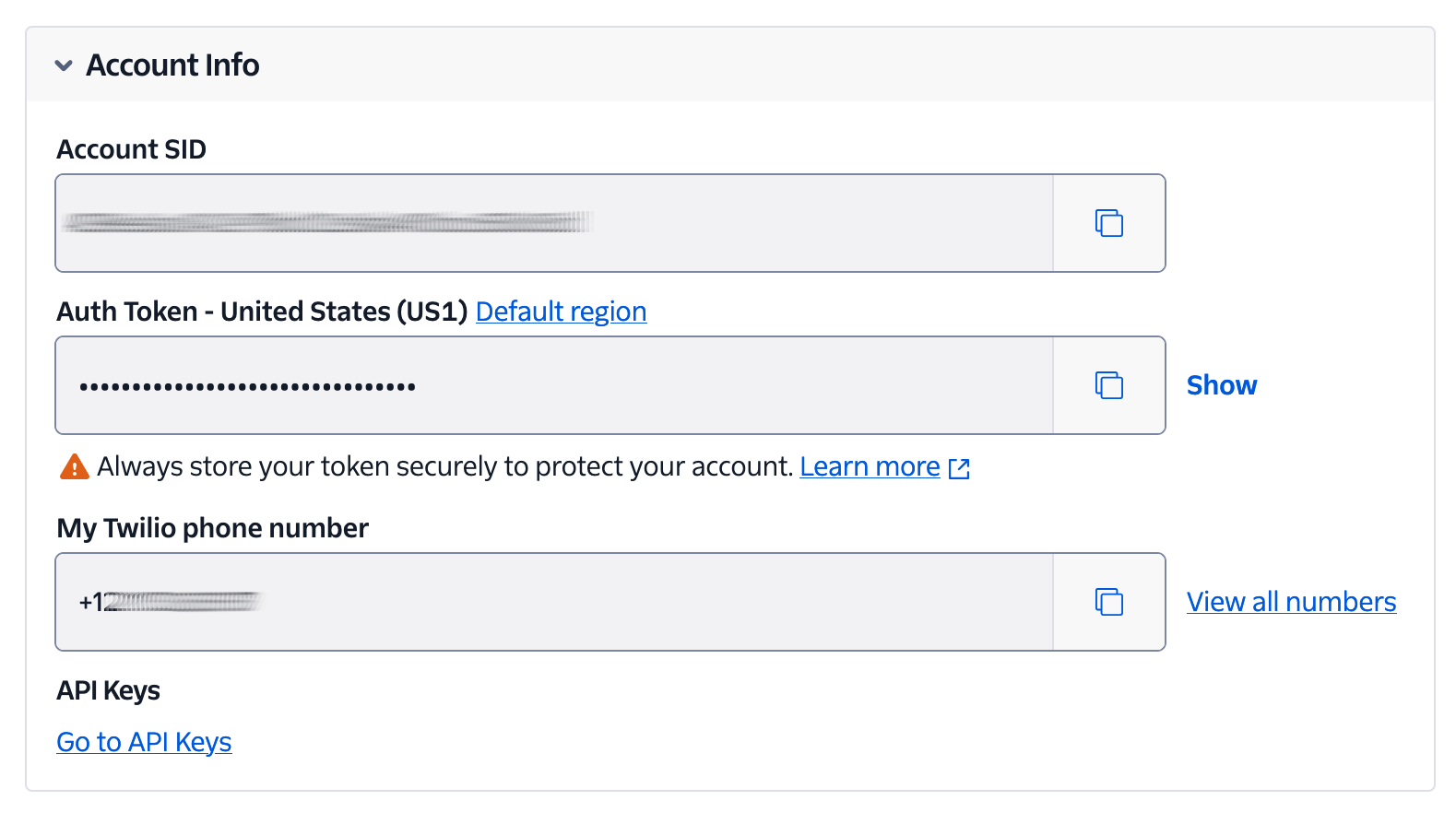 The Account Info panel of the Twilio Console, showing a user's Account SID, Auth Token, and phone number, where the Account SID and phone number have been partially or completely redacted.